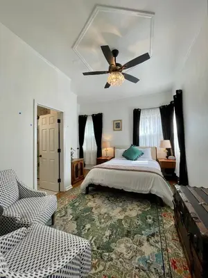 a bedroom with a bed and a ceiling fan at Flora House Denver in Denver