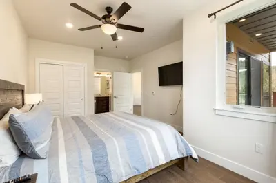 a bedroom with a bed and a ceiling fan at 204 Clearwater Lofts condo in Keystone