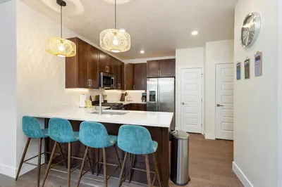 a kitchen with a island with blue bar stools at 204 Clearwater Lofts condo in Keystone