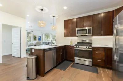 a kitchen with wooden cabinets and stainless steel appliances at 204 Clearwater Lofts condo in Keystone