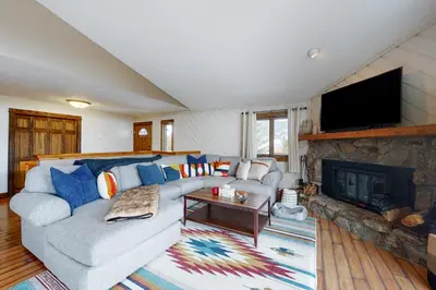 a living room with a couch and a fireplace at The Nugget Ski Chalet in Dillon