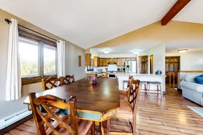 a dining room and kitchen with a table and chairs at The Nugget Ski Chalet in Dillon