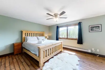 a bedroom with a bed and a ceiling fan at The Nugget Ski Chalet in Dillon