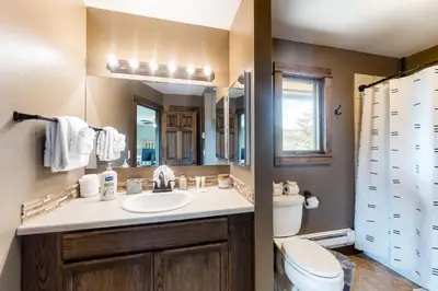 a bathroom with a sink and a toilet and a mirror at The Nugget Ski Chalet in Dillon