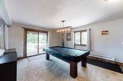 a pool table in the middle of a room at The Nugget Ski Chalet in Dillon