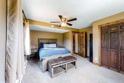 a bedroom with a bed and a ceiling fan at The Nugget Ski Chalet in Dillon