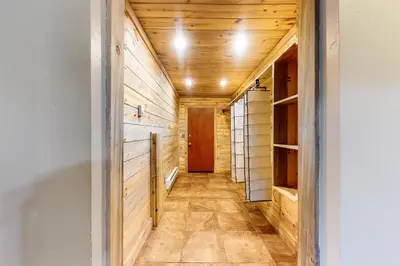 a hallway in a house with wooden walls and a door at The Nugget Ski Chalet in Dillon