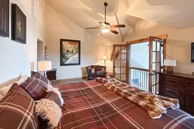 a bedroom with a bed and a ceiling fan at Pine Peak in Fraser