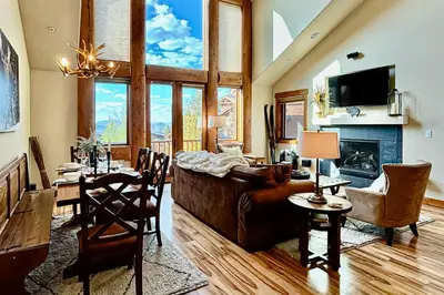 a living room with a couch and a dining room at Pine Peak in Fraser