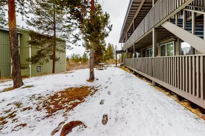 a snow covered sidewalk next to a building at Hi Country Haus Hideaway in Winter Park