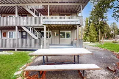 a picnic table in front of a building at Hi Country Haus Hideaway in Winter Park