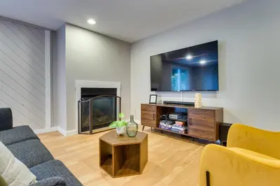 a living room with a couch and a tv at Scenic Conifer Getaway with Game Room and Hot Tub! in Conifer