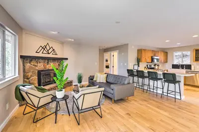 a living room with a couch and chairs and a fireplace at Scenic Conifer Getaway with Game Room and Hot Tub! in Conifer