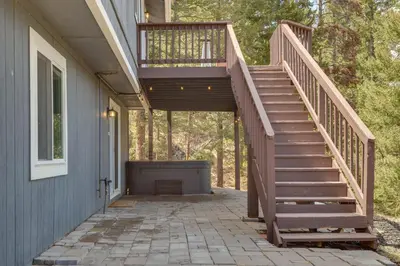 a wooden staircase leading up to a house at Scenic Conifer Getaway with Game Room and Hot Tub! in Conifer