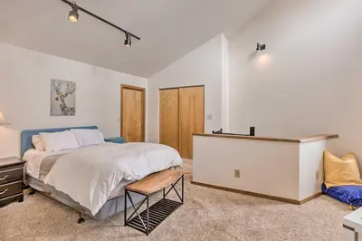 a bedroom with a bed and a dresser in a room at Private Balcony and Resort Perks Silverthorne Condo in Silverthorne