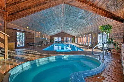 a large pool in a house with a wooden ceiling at Private Balcony and Resort Perks Silverthorne Condo in Silverthorne