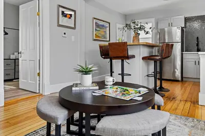 a kitchen and dining room with a table and chairs at Charming Vintage Cottage with Hot Tub & Free Bikes! in Fort Collins