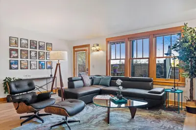 a living room with a couch and a table and chairs at Sleek Condo - Near Park, Poudre River and Old Town in Fort Collins