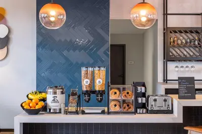 a bakery counter with donuts and fruit on it at Atwell Suites Denver Airport - Tower Road by IHG in Denver