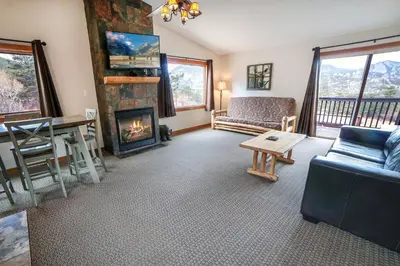 a living room with a couch and a fireplace at Rocky Mountain Retreat 1B by Rocky Mountain Resorts in Estes Park