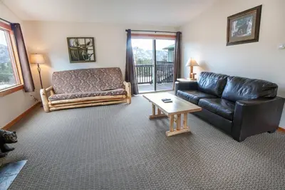 a living room with a leather couch and a coffee table at Rocky Mountain Retreat 1B by Rocky Mountain Resorts in Estes Park