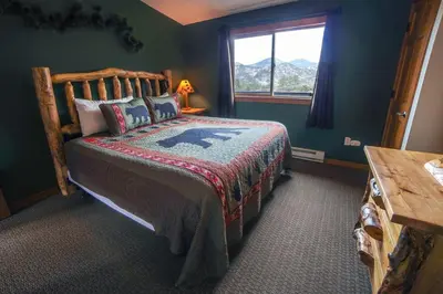 a bedroom with a bed in a room with a window at Rocky Mountain Retreat 1B by Rocky Mountain Resorts in Estes Park