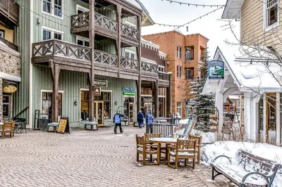 a street in a city with benches and buildings at Fraser Crossing 3404 in Winter Park