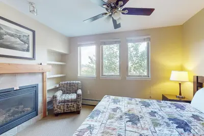 a bedroom with a bed and a fireplace at Fraser Crossing 3404 in Winter Park