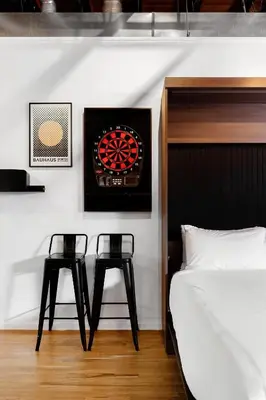 a bedroom with two stools next to a bed and a board at Hotel Residential of Denver in Denver