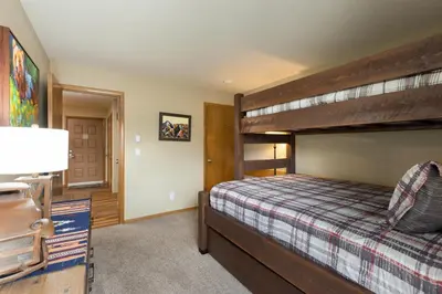 a bedroom with a bunk bed and a lamp at 309 Snowdance Manor condo in Keystone