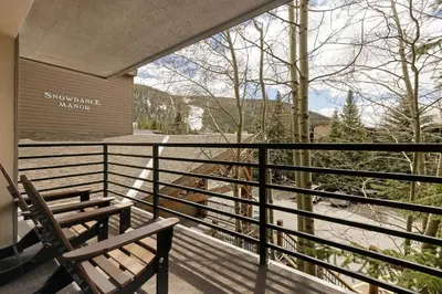 a balcony with two benches and a view of a mountain at 309 Snowdance Manor condo in Keystone
