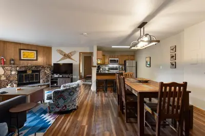 a kitchen and living room with a table and chairs at 309 Snowdance Manor condo in Keystone