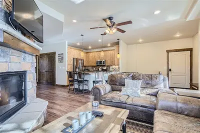 a living room with a couch and a fireplace at Condos Off Main 15 condo in Frisco