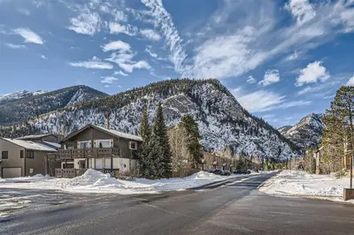 a house on a snowy street with a mountain at Condos Off Main 15 condo in Frisco