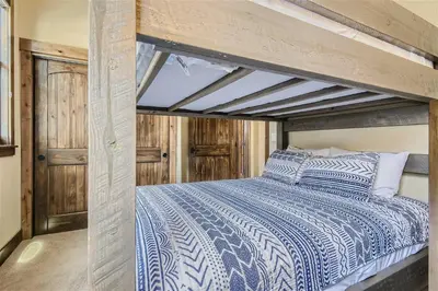 a bedroom with a bed with a blue and white comforter at Condos Off Main 15 condo in Frisco