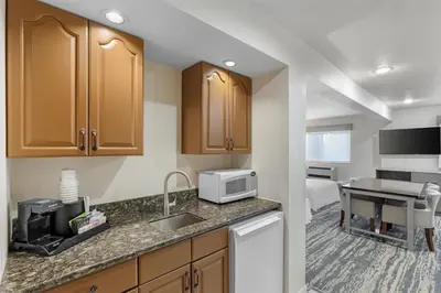 a kitchen with a sink and a microwave at Best Western Alpenglo Lodge in Winter Park