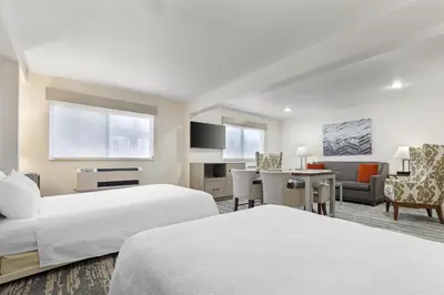 a hotel room with two beds and a desk at Best Western Alpenglo Lodge in Winter Park