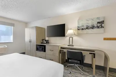 a hotel room with a bed and a desk with a computer at Best Western Alpenglo Lodge in Winter Park