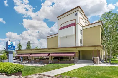 a building with a parking lot in front of it at Best Western Alpenglo Lodge in Winter Park