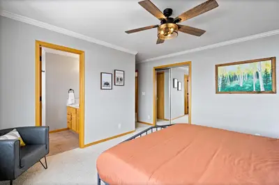 a bedroom with a bed and a ceiling fan at Summit Sanctuary in Silverthorne