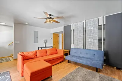 a living room with a couch and a ceiling fan at Summit Sanctuary in Silverthorne