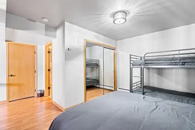 a bedroom with two bunk beds and a mirror at Summit Sanctuary in Silverthorne