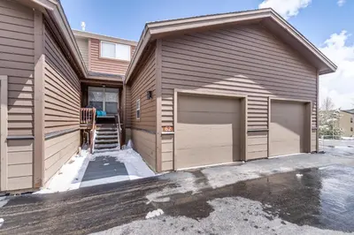 a house with two garage doors in a driveway at Summit Sanctuary in Silverthorne