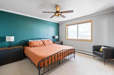 a bedroom with a bed and a ceiling fan at Summit Sanctuary in Silverthorne