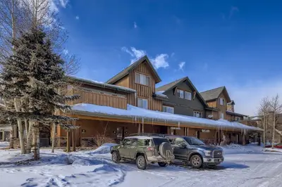 a car parked in front of a house in the snow at Drake Landing #A8 condo in Frisco