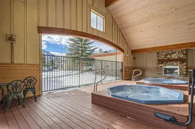 a large room with a hot tub on a deck at Drake Landing #A8 condo in Frisco