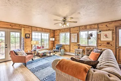 a living room with wooden walls and a couch and chairs at 4 Mi to Rocky Moutain Natl Park Grand Lake Home! in Grand Lake