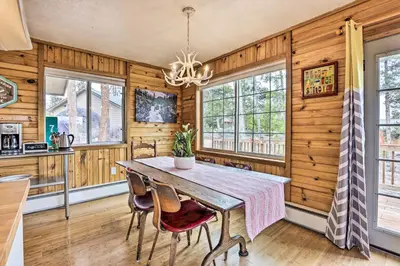 a dining room with wooden walls and a table and chairs at 4 Mi to Rocky Moutain Natl Park Grand Lake Home! in Grand Lake