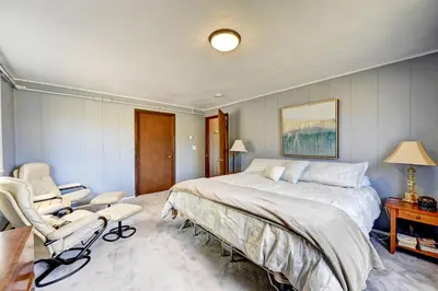 a bedroom with a large bed and two chairs at 4 Mi to Rocky Moutain Natl Park Grand Lake Home! in Grand Lake