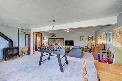 a living room with a foos ball on a table at 4 Mi to Rocky Moutain Natl Park Grand Lake Home! in Grand Lake